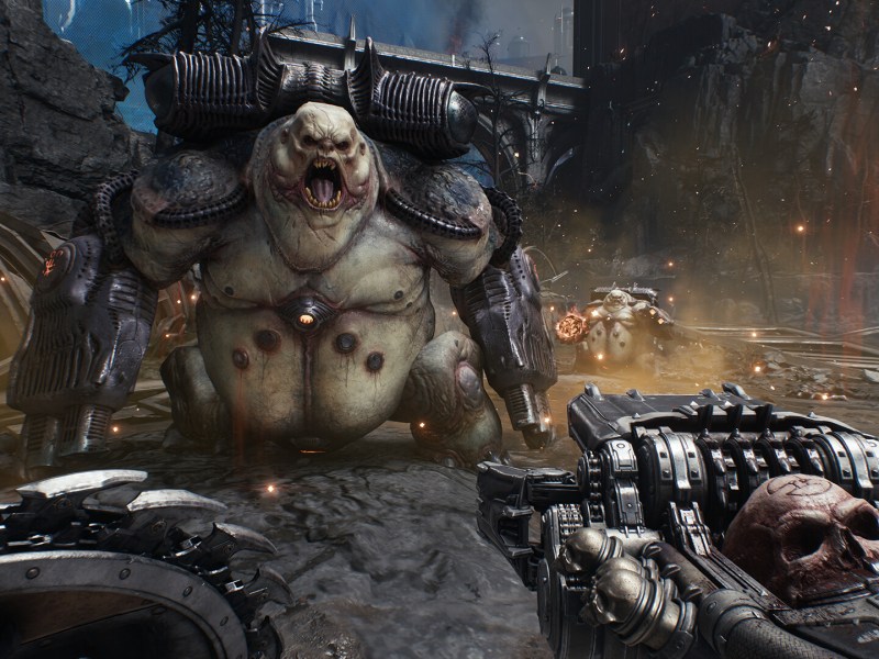 Screenshot aus Doom: The Dark Ages. Der Doom Slayer ist zu sehen, wie er einen Feind mit einer neuen Waffe entgegentritt.